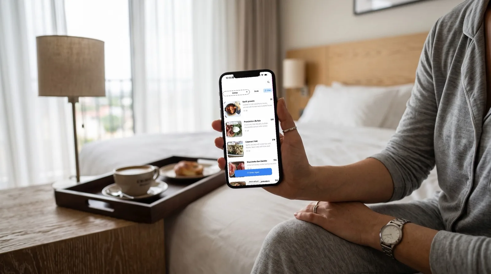 A hotel guest browsing the Asky menu on their phone beside a room service tray