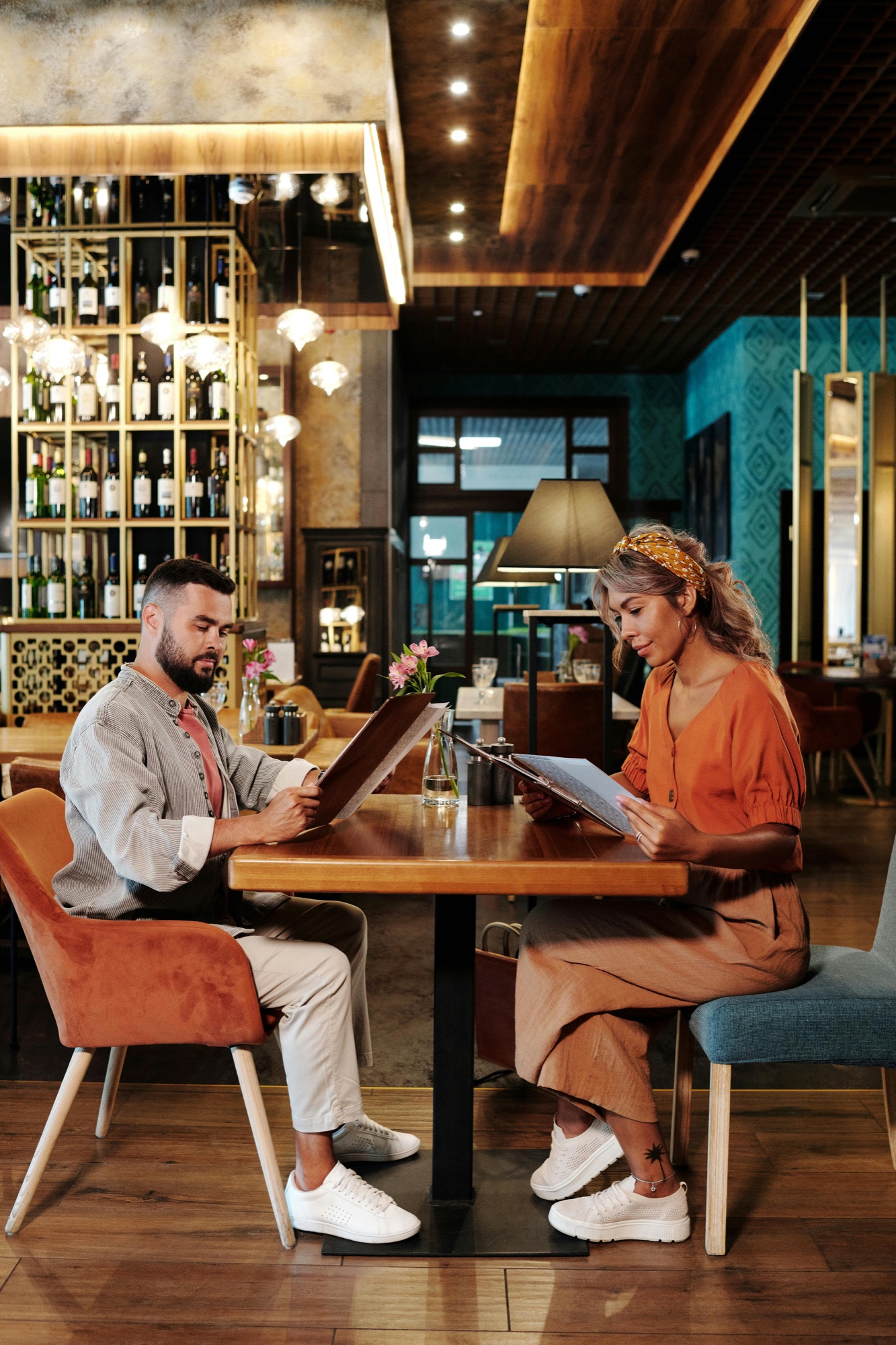 A couple reading menus at a restaurant table